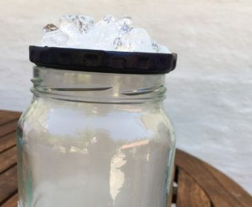 A picture of a jar with an artificial cloud inside, and ice on the lid